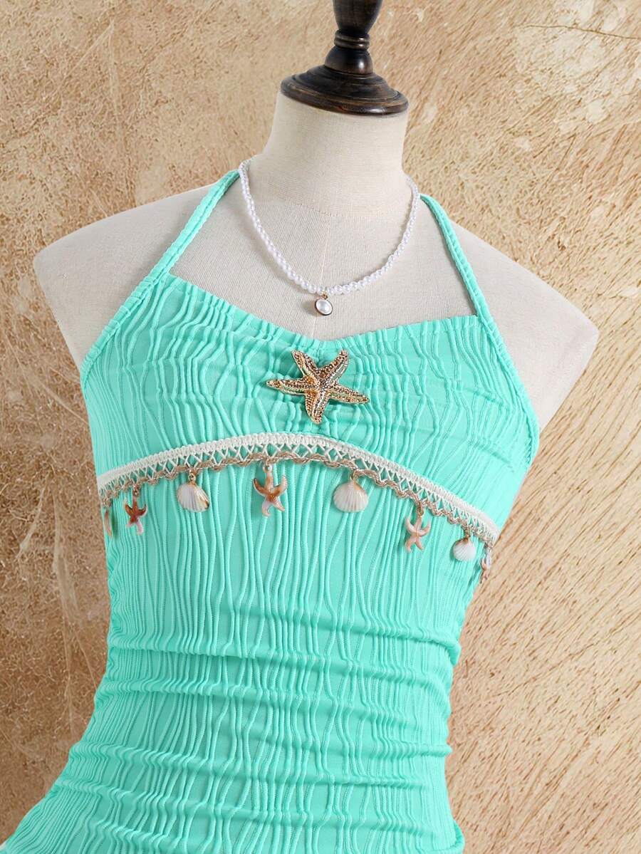 Tween girls apricot sleeveless halter mini dress with textured starfish and shell decor, shirred tiered layer, high waist, and flounce hem.