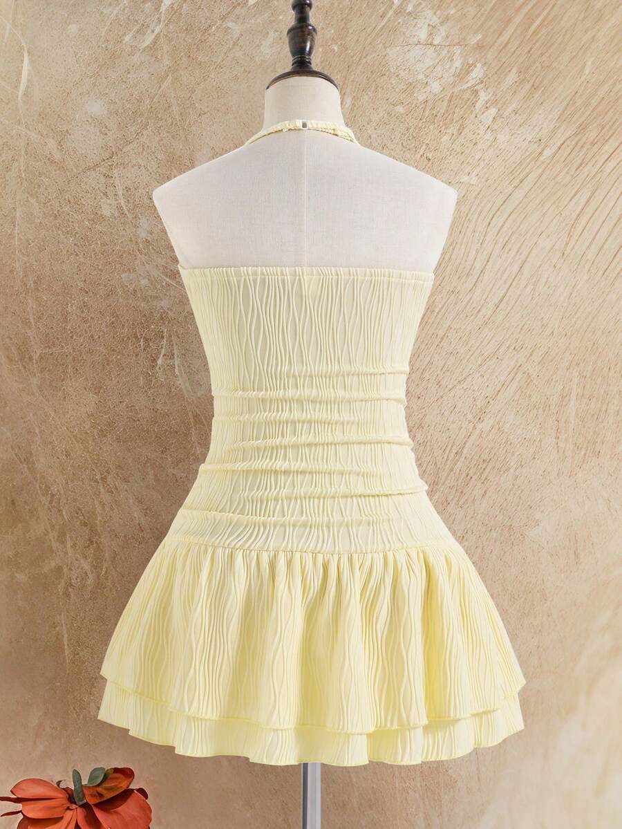 Tween girls apricot sleeveless halter mini dress with textured starfish and shell decor, shirred tiered layer, high waist, and flounce hem.