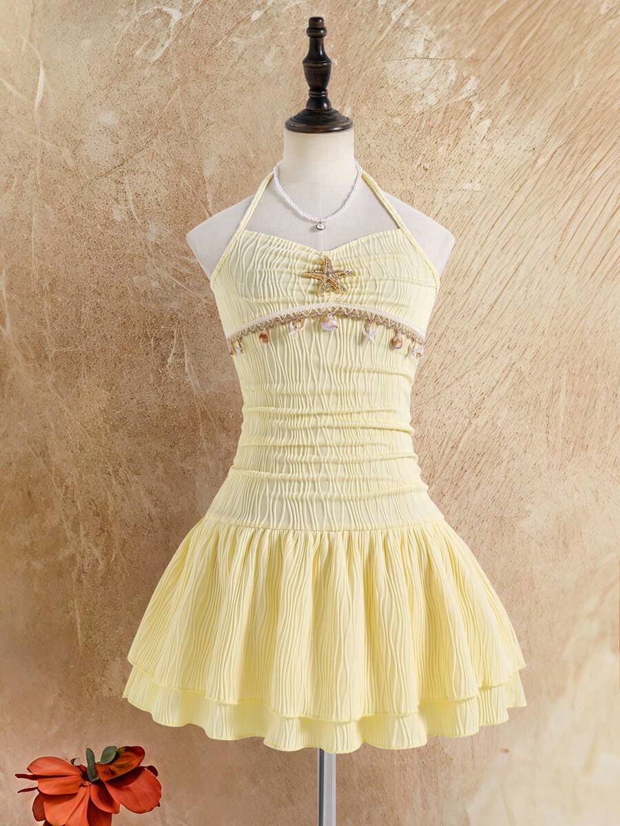 Tween girls apricot sleeveless halter mini dress with textured starfish and shell decor, shirred tiered layer, high waist, and flounce hem.