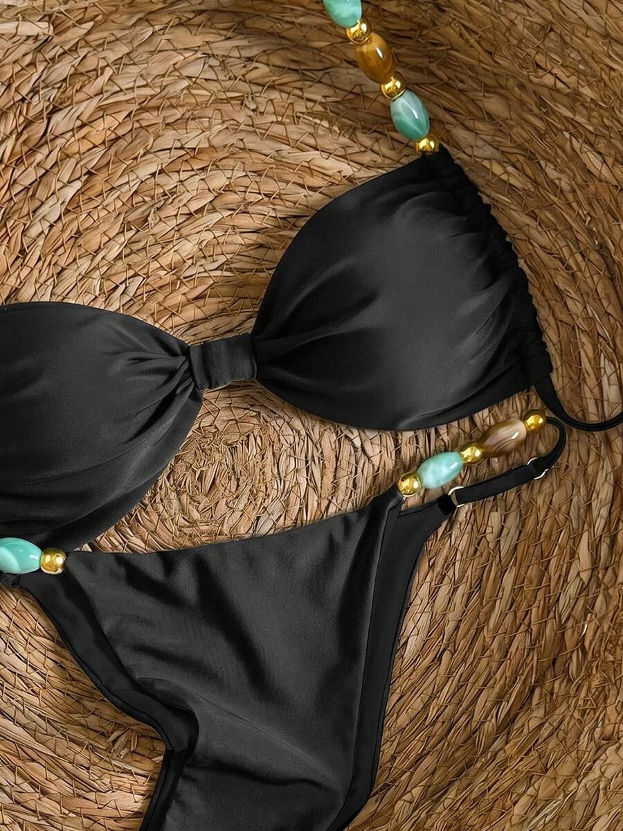 Women's green halter neck bikini set featuring color-block beaded shoulder straps, back tie detail, and high cut bottoms.