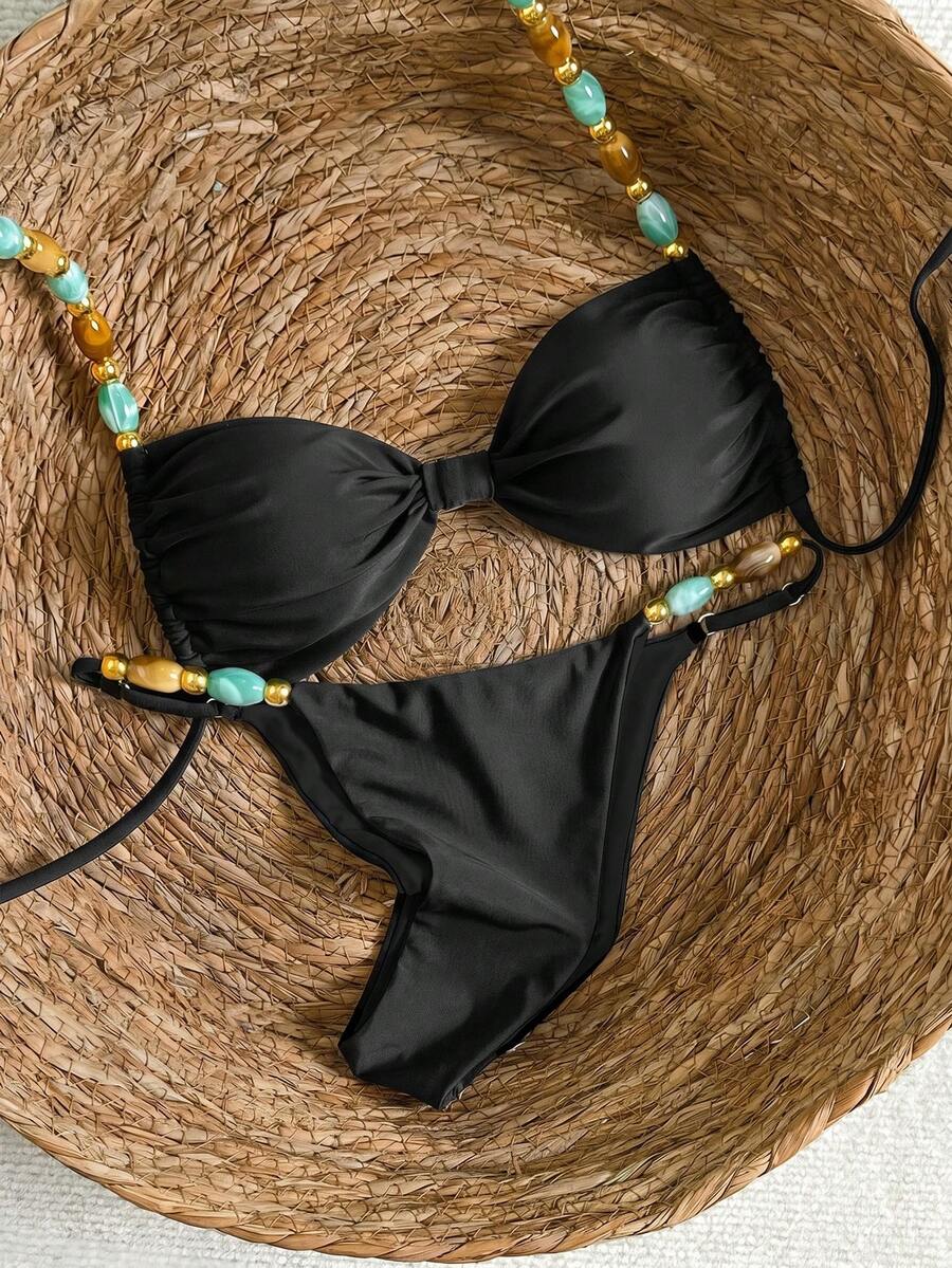 Women's green halter neck bikini set featuring color-block beaded shoulder straps, back tie detail, and high cut bottoms.