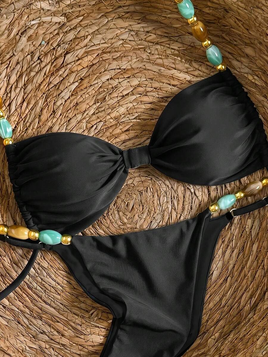 Women's green halter neck bikini set featuring color-block beaded shoulder straps, back tie detail, and high cut bottoms.