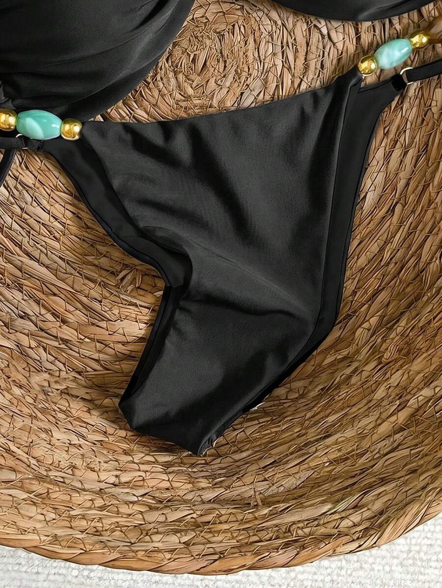 Women's green halter neck bikini set featuring color-block beaded shoulder straps, back tie detail, and high cut bottoms.
