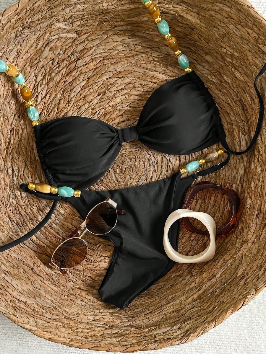 Women's green halter neck bikini set featuring color-block beaded shoulder straps, back tie detail, and high cut bottoms.