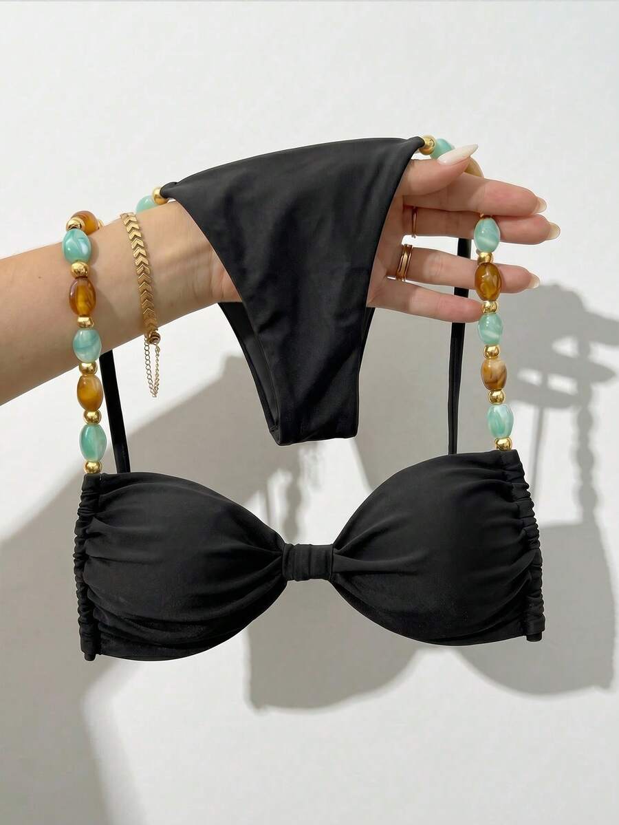 Women's green halter neck bikini set featuring color-block beaded shoulder straps, back tie detail, and high cut bottoms.