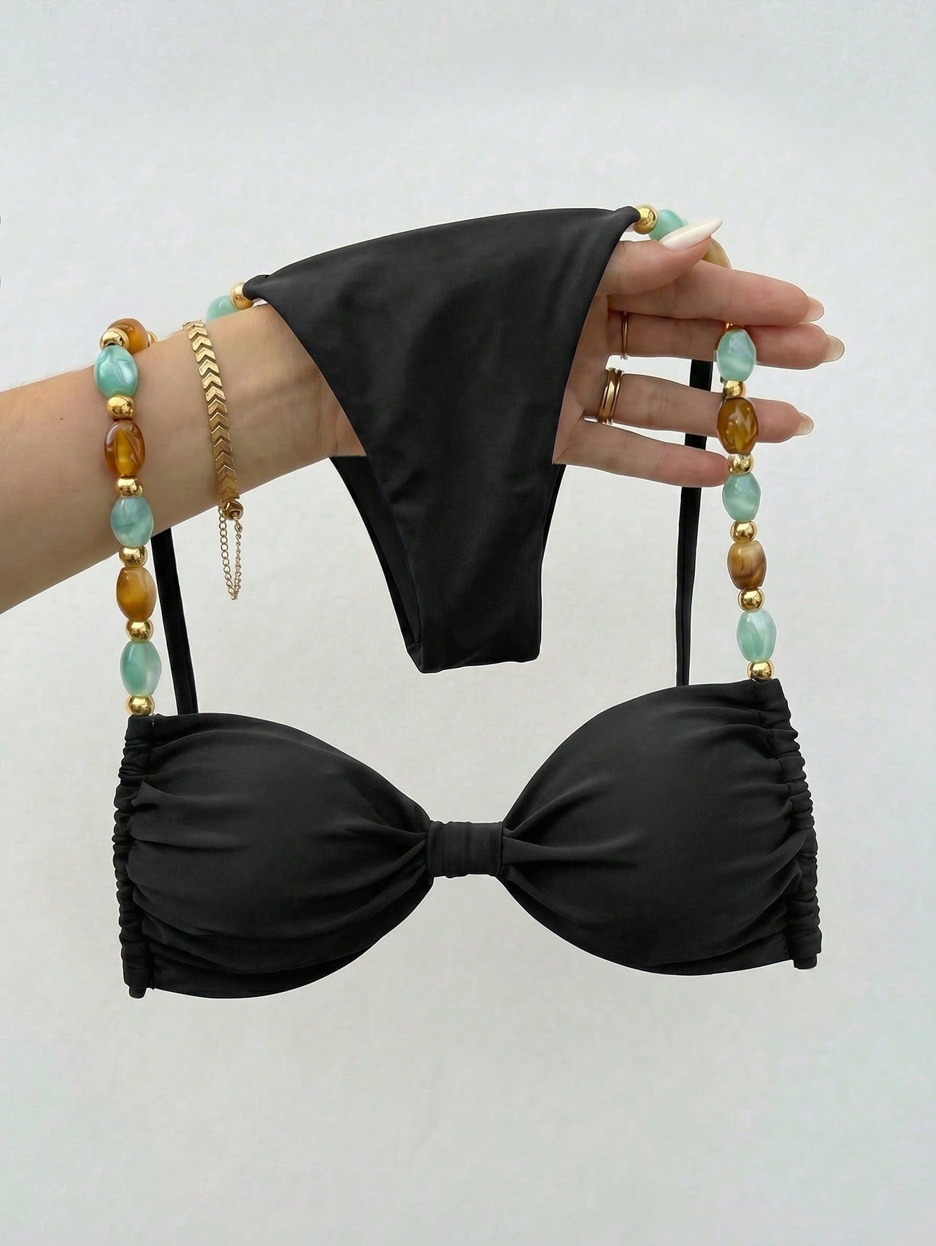 Women's green halter neck bikini set featuring color-block beaded shoulder straps, back tie detail, and high cut bottoms.