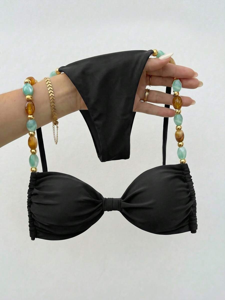 Women's green halter neck bikini set featuring color-block beaded shoulder straps, back tie detail, and high cut bottoms.
