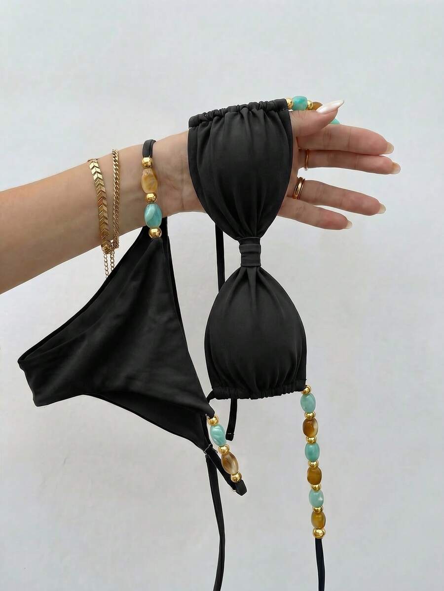 Women's green halter neck bikini set featuring color-block beaded shoulder straps, back tie detail, and high cut bottoms.
