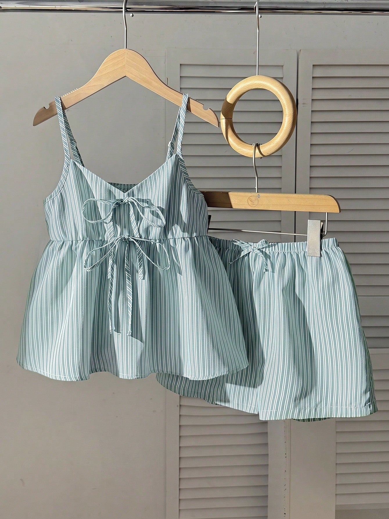 Tween girl 2-piece summer set with a black and white sleeveless striped spaghetti strap tank top with ruffle details and matching casual shorts.