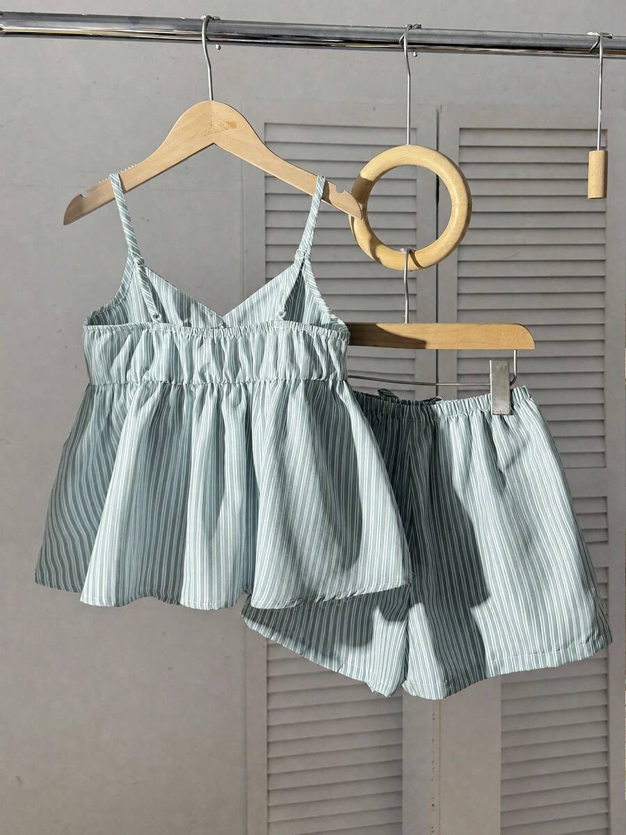 Tween girl 2-piece summer set with a black and white sleeveless striped spaghetti strap tank top with ruffle details and matching casual shorts.