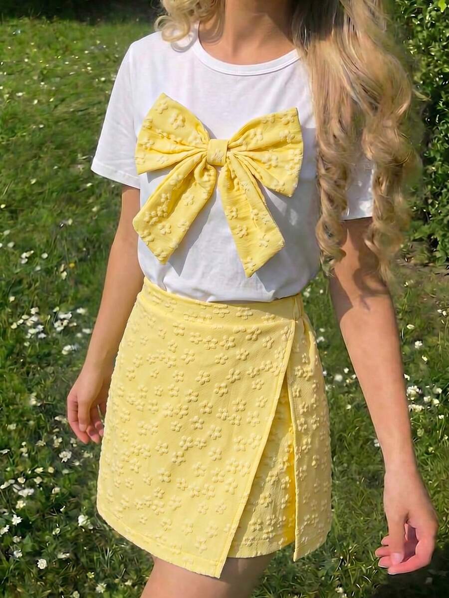 Tween girls 2-piece blue outfit featuring a short sleeve round neck t-shirt with a bow front detail and an asymmetric wrap skort.