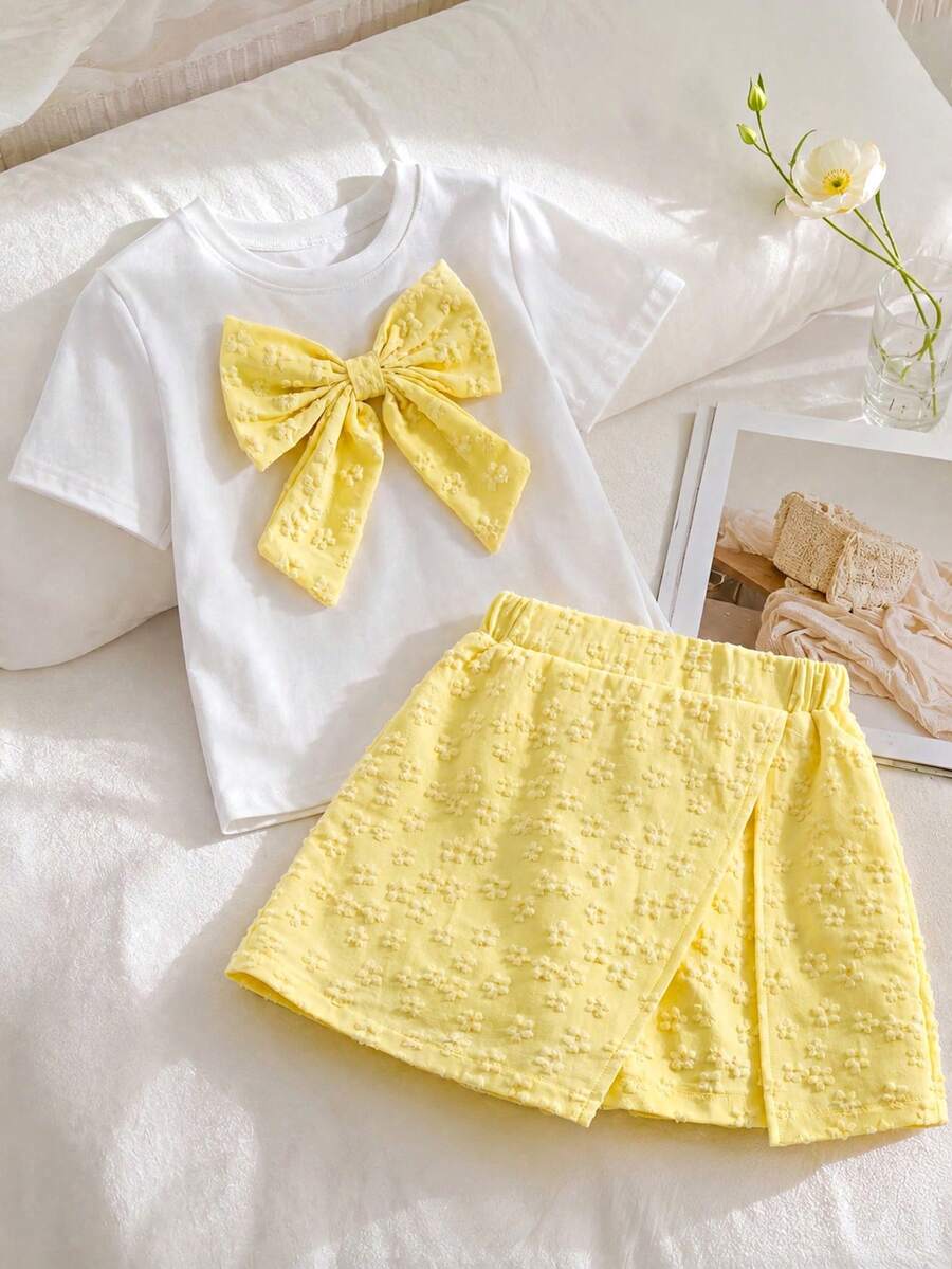 Tween girls 2-piece blue outfit featuring a short sleeve round neck t-shirt with a bow front detail and an asymmetric wrap skort.