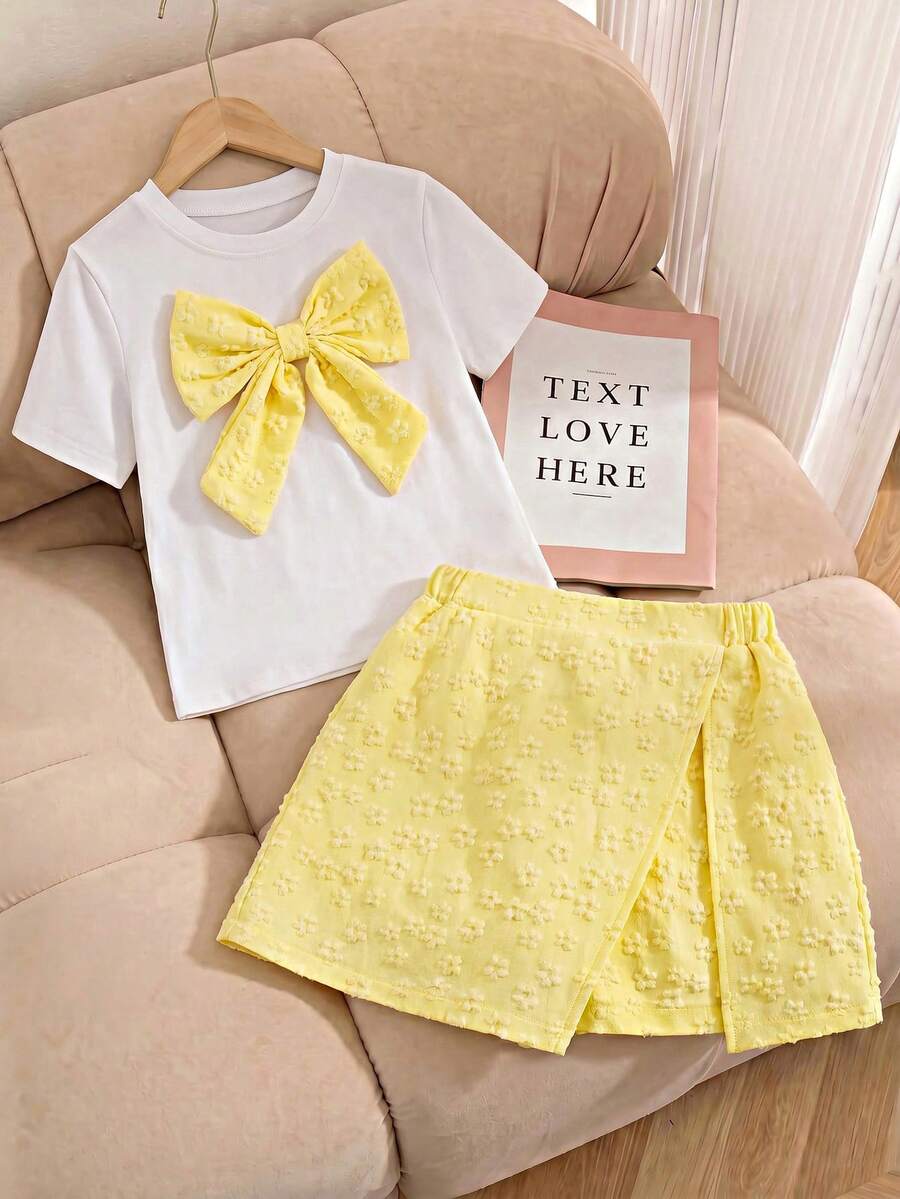 Tween girls 2-piece blue outfit featuring a short sleeve round neck t-shirt with a bow front detail and an asymmetric wrap skort.