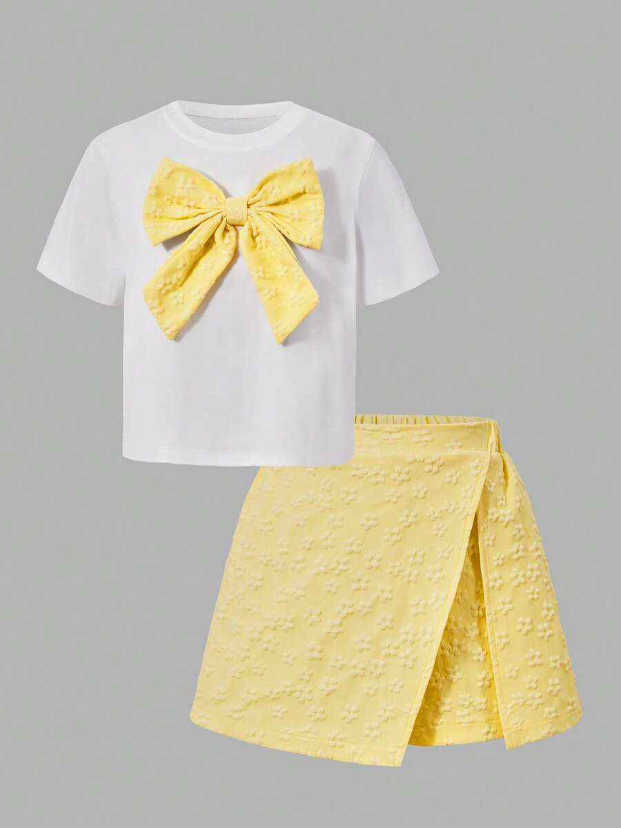 Tween girls 2-piece blue outfit featuring a short sleeve round neck t-shirt with a bow front detail and an asymmetric wrap skort.