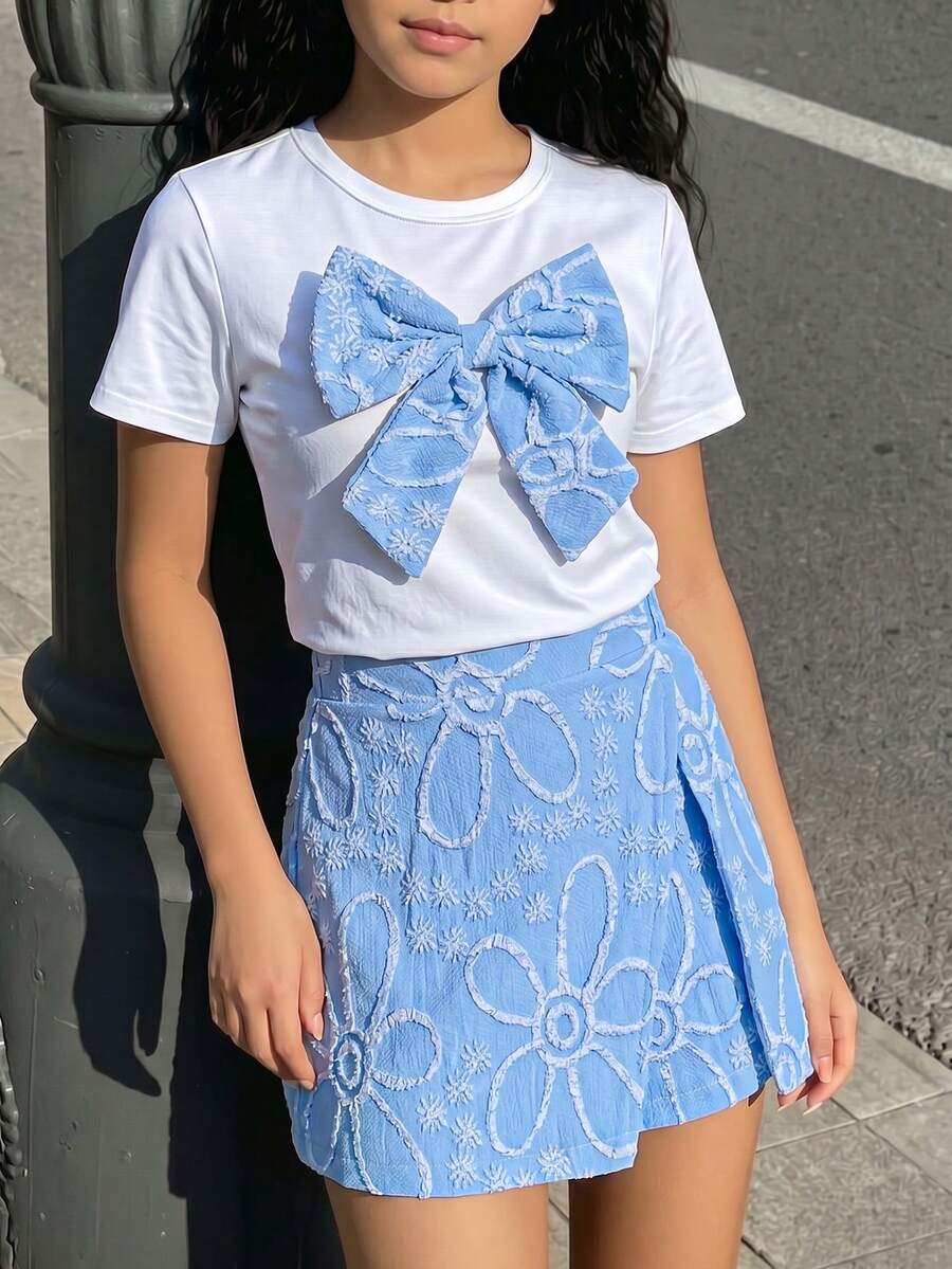 Tween girls 2-piece blue outfit featuring a short sleeve round neck t-shirt with a bow front detail and an asymmetric wrap skort.