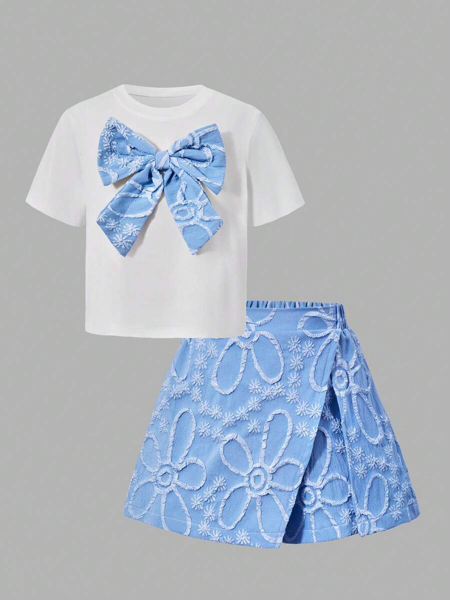 Tween girls 2-piece blue outfit featuring a short sleeve round neck t-shirt with a bow front detail and an asymmetric wrap skort.