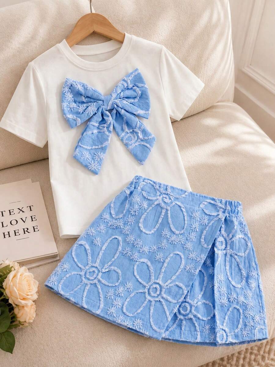 Tween girls 2-piece blue outfit featuring a short sleeve round neck t-shirt with a bow front detail and an asymmetric wrap skort.