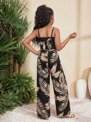 Tween girl wearing a black sleeveless spaghetti strap camisole top with 3D bow decor and matching leopard print wide leg long pants.