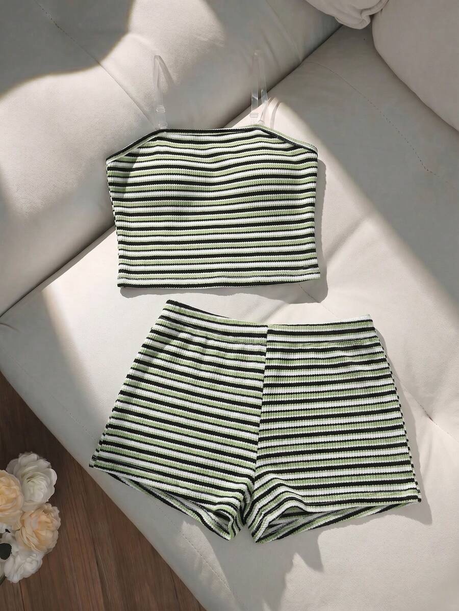 Tween girls black and white striped two-piece set featuring a spaghetti strap micro crop tank top with lettuce trim and ruffle hem paired with matching slim fit shorts.