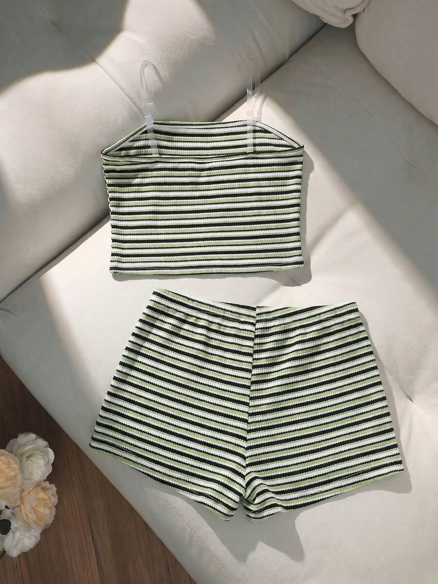 Tween girls black and white striped two-piece set featuring a spaghetti strap micro crop tank top with lettuce trim and ruffle hem paired with matching slim fit shorts.
