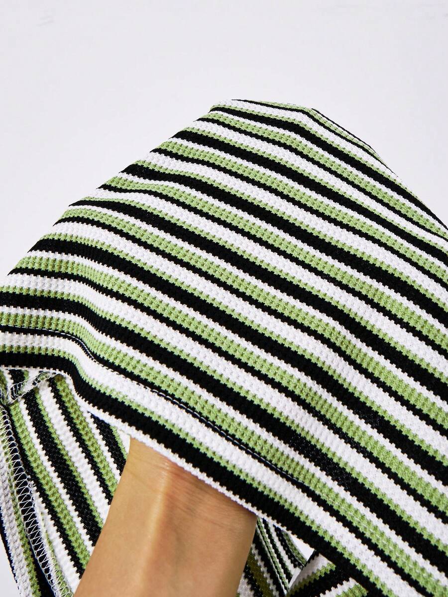 Tween girls black and white striped two-piece set featuring a spaghetti strap micro crop tank top with lettuce trim and ruffle hem paired with matching slim fit shorts.