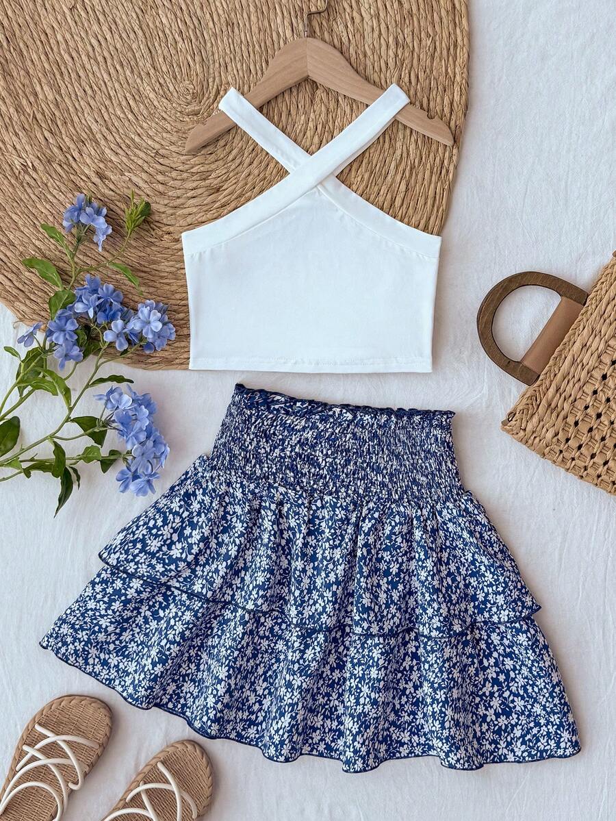 Tween girls blue and white 2-piece set with a striped halter neck vest top and a floral high-waist tiered paperbag skirt.