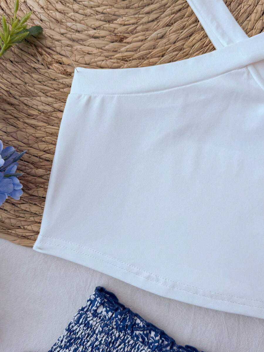 Tween girls blue and white 2-piece set with a striped halter neck vest top and a floral high-waist tiered paperbag skirt.
