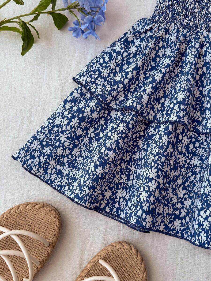 Tween girls blue and white 2-piece set with a striped halter neck vest top and a floral high-waist tiered paperbag skirt.