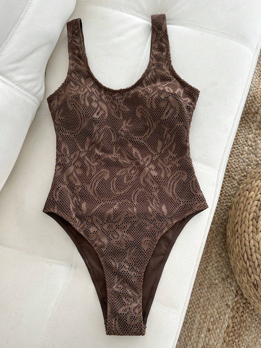 Women's solid color one-piece swimsuit featuring a backless scoop neck design and high cut fit