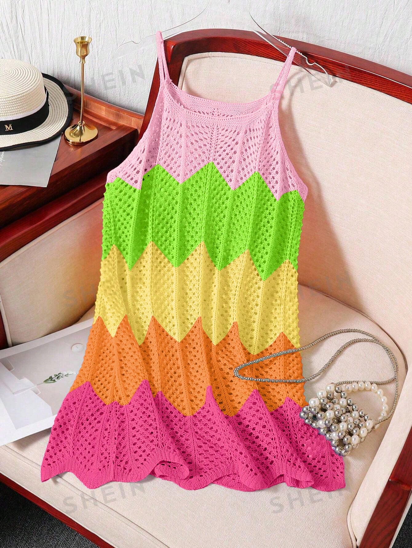 Girls' multicolor rainbow gradient crochet beach cover up with hollow-out knit design, spaghetti straps, sleeveless A-line shape, and semi-sheer finish.
