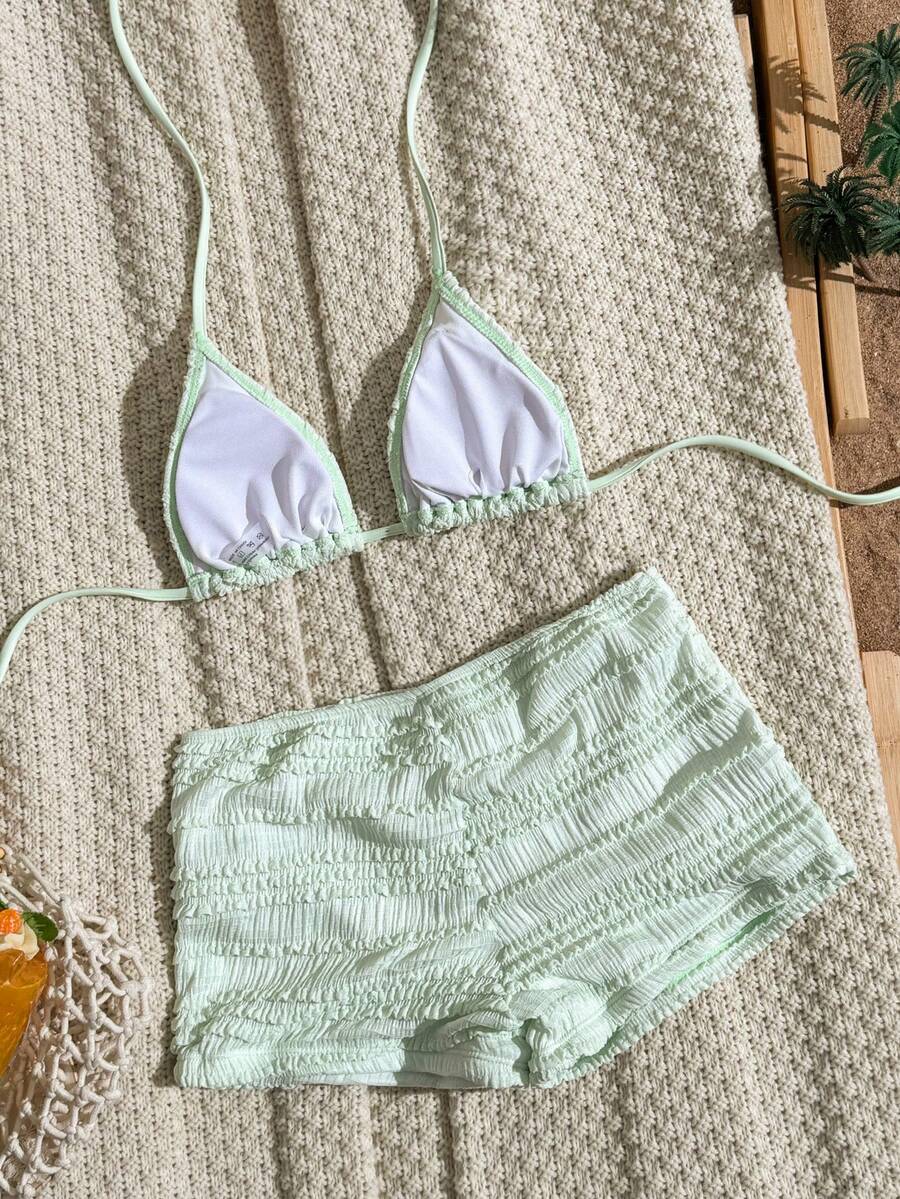Women's apricot two-piece swimsuit set with a halter tie-back top and matching high stretch shorts.