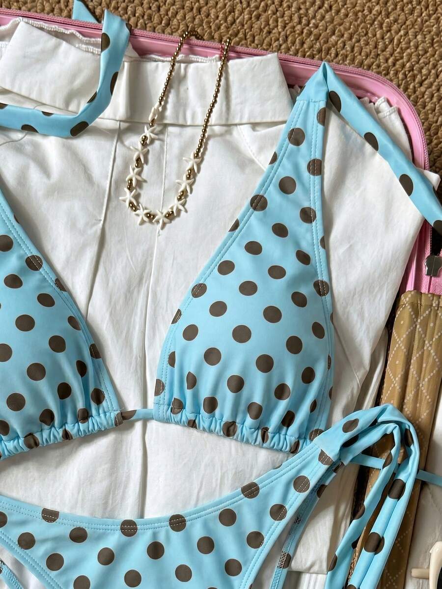 Women's polka dot two-piece bikini set featuring a backless halter top with triangle cups and matching tie-side bottoms.