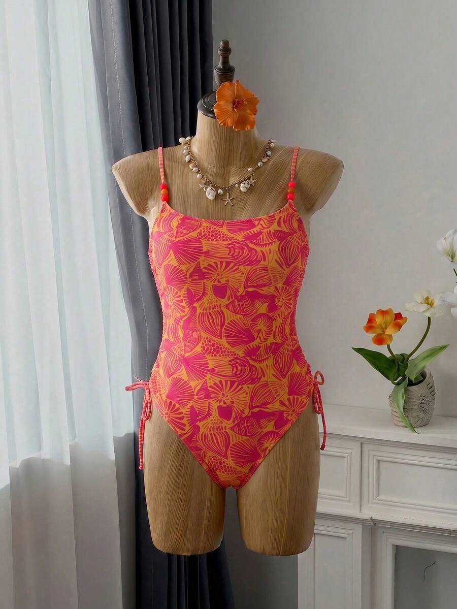 Women's blue backless one-piece swimsuit featuring spaghetti straps, wireless bra with removable padding, and drawstring details.