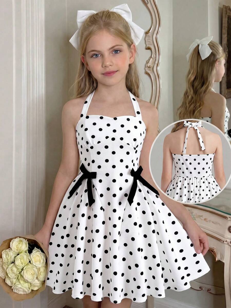 Black and white polka dot cami dress for tween girls featuring a square neckline, high waist, and flared short A-line hem.