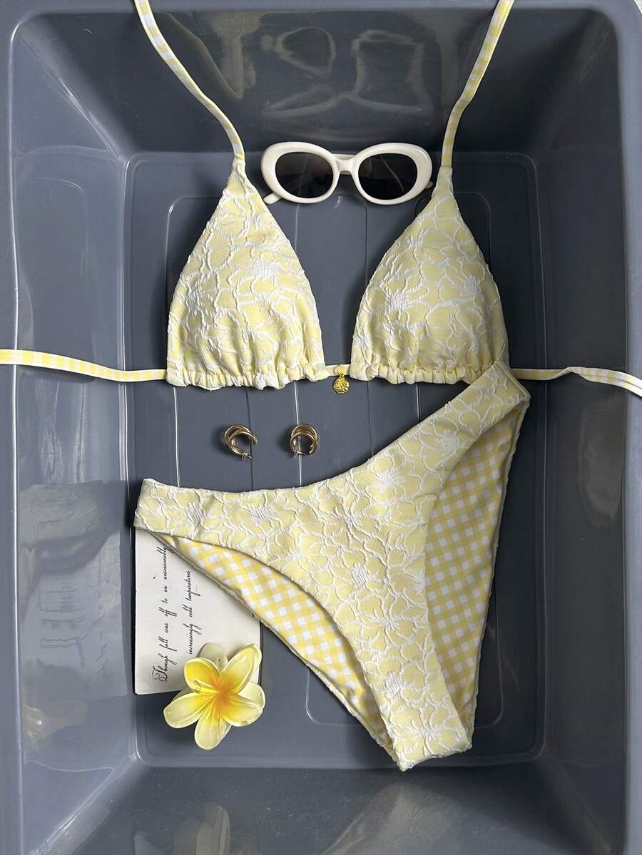 Women's black textured plaid 2-piece bikini set featuring a halter neckline, wireless triangle cups with removable padding, and mid-waist bottoms.