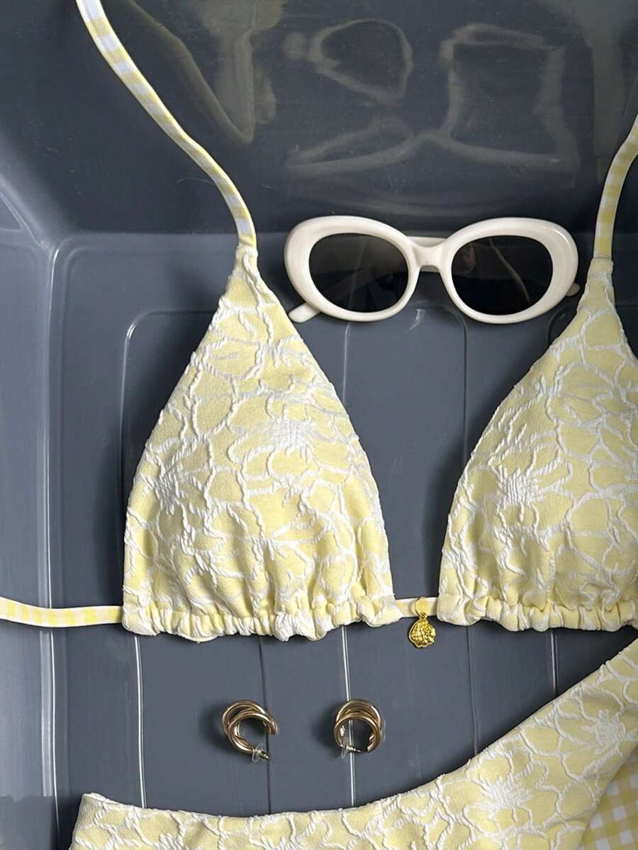Women's black textured plaid 2-piece bikini set featuring a halter neckline, wireless triangle cups with removable padding, and mid-waist bottoms.