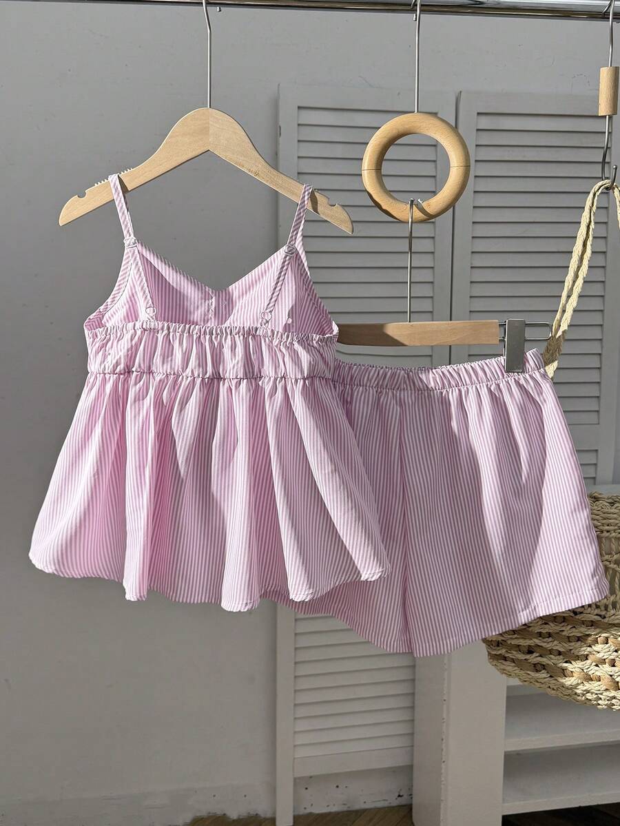 Tween girl 2-piece summer set with a black and white sleeveless striped spaghetti strap tank top with ruffle details and matching casual shorts.