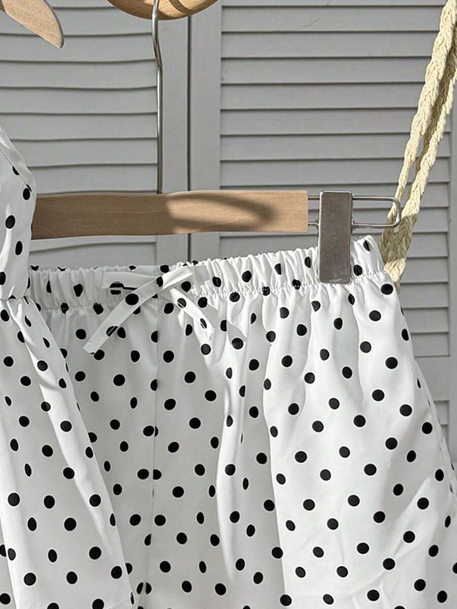 Tween girl 2-piece summer set with a black and white sleeveless striped spaghetti strap tank top with ruffle details and matching casual shorts.