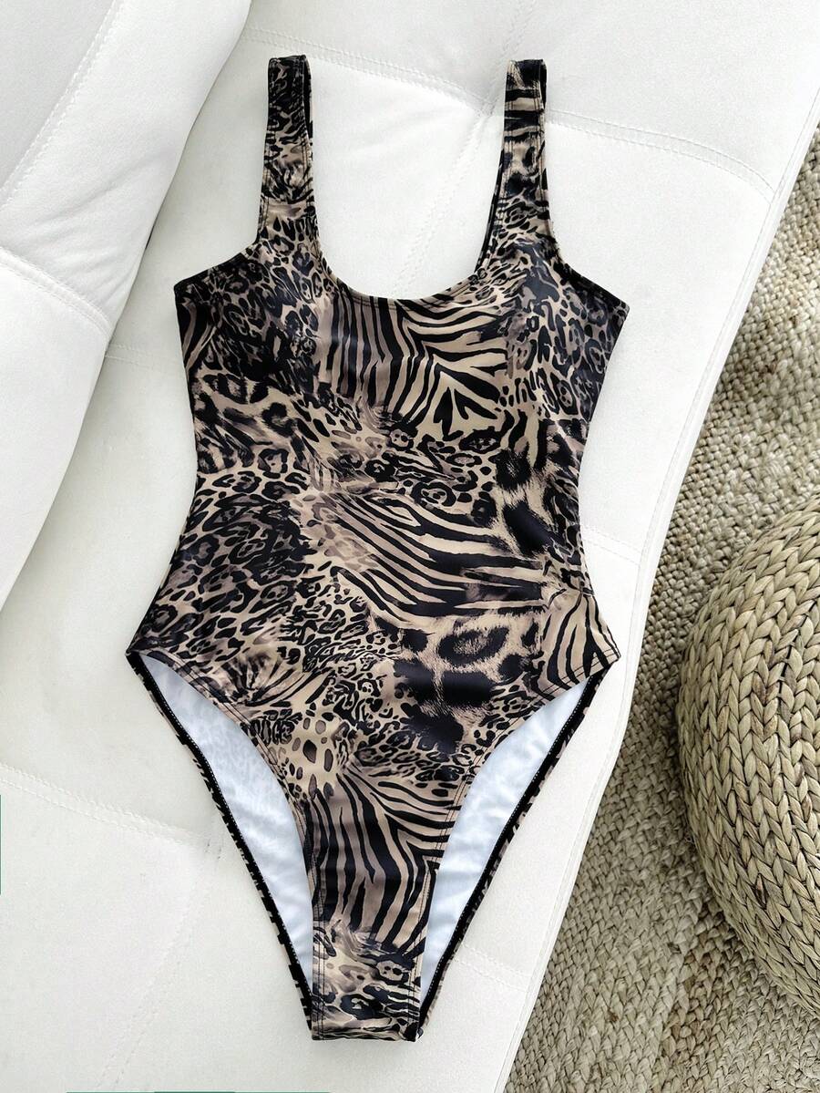 Women's solid color one-piece swimsuit featuring a backless scoop neck design and high cut fit