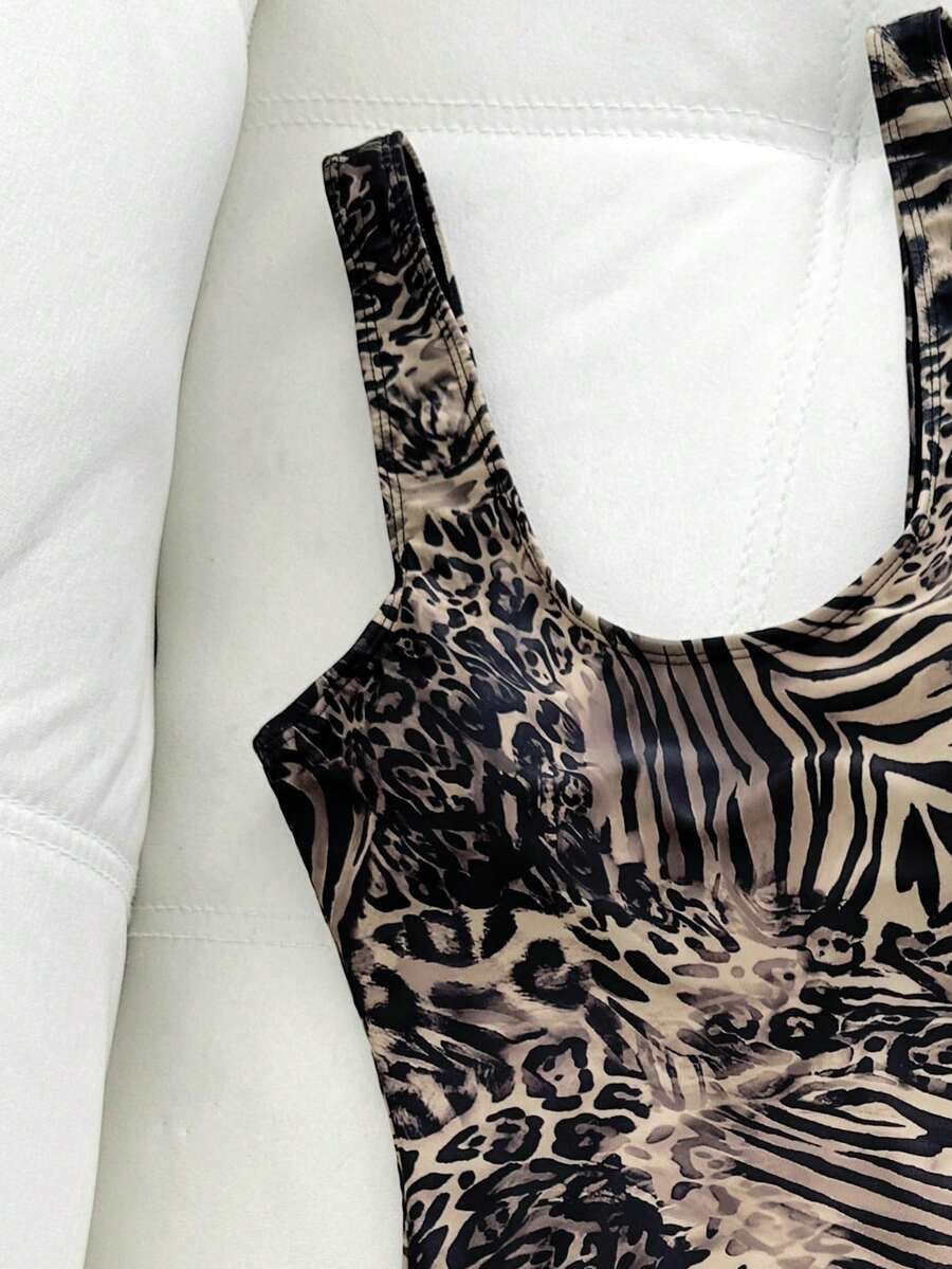 Women's solid color one-piece swimsuit featuring a backless scoop neck design and high cut fit