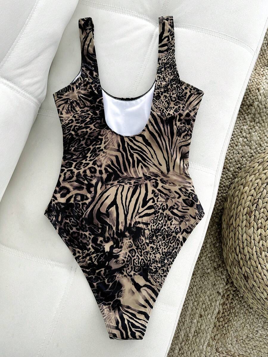 Women's solid color one-piece swimsuit featuring a backless scoop neck design and high cut fit