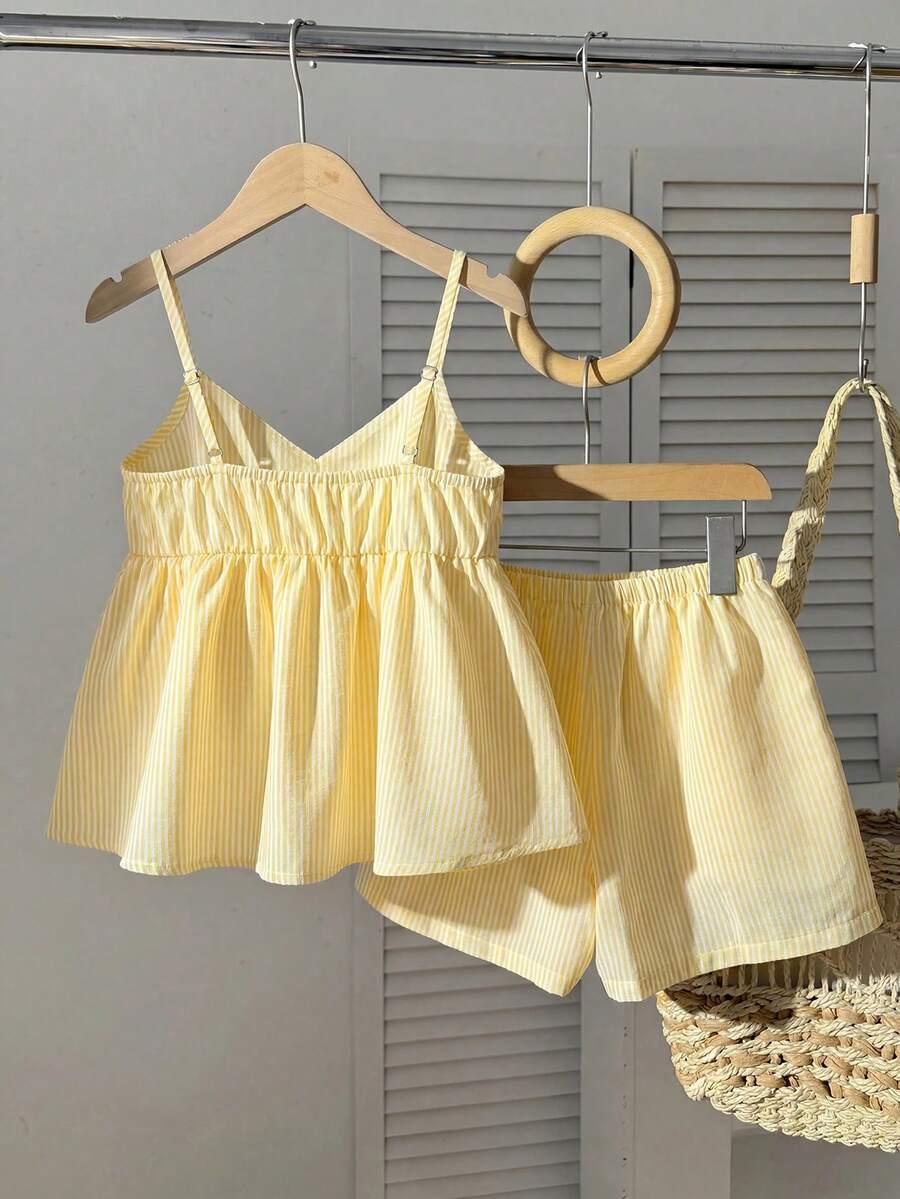Tween girl 2-piece summer set with a black and white sleeveless striped spaghetti strap tank top with ruffle details and matching casual shorts.