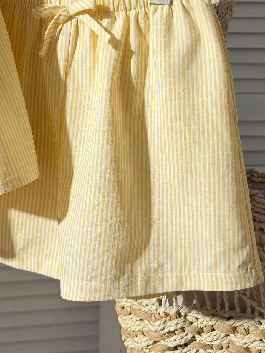 Tween girl 2-piece summer set with a black and white sleeveless striped spaghetti strap tank top with ruffle details and matching casual shorts.