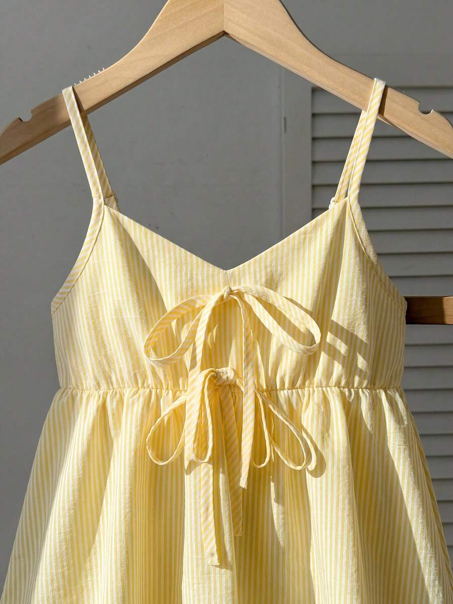 Tween girl 2-piece summer set with a black and white sleeveless striped spaghetti strap tank top with ruffle details and matching casual shorts.