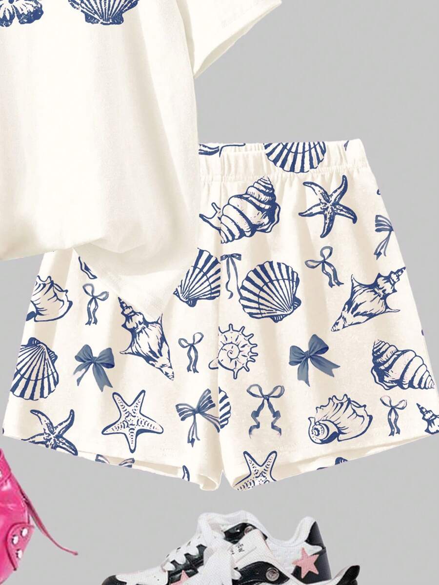 Tween girls 2-piece summer casual outfit featuring a multicolor seashell print short sleeve T-shirt with drop shoulders and matching loose fit shorts with pockets.
