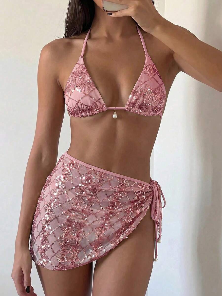 Women's 3-piece blue tropical shell print bikini set featuring a halter bralette top, low-waist tie-side bottom, and a matching sheer mesh cover-up skirt.