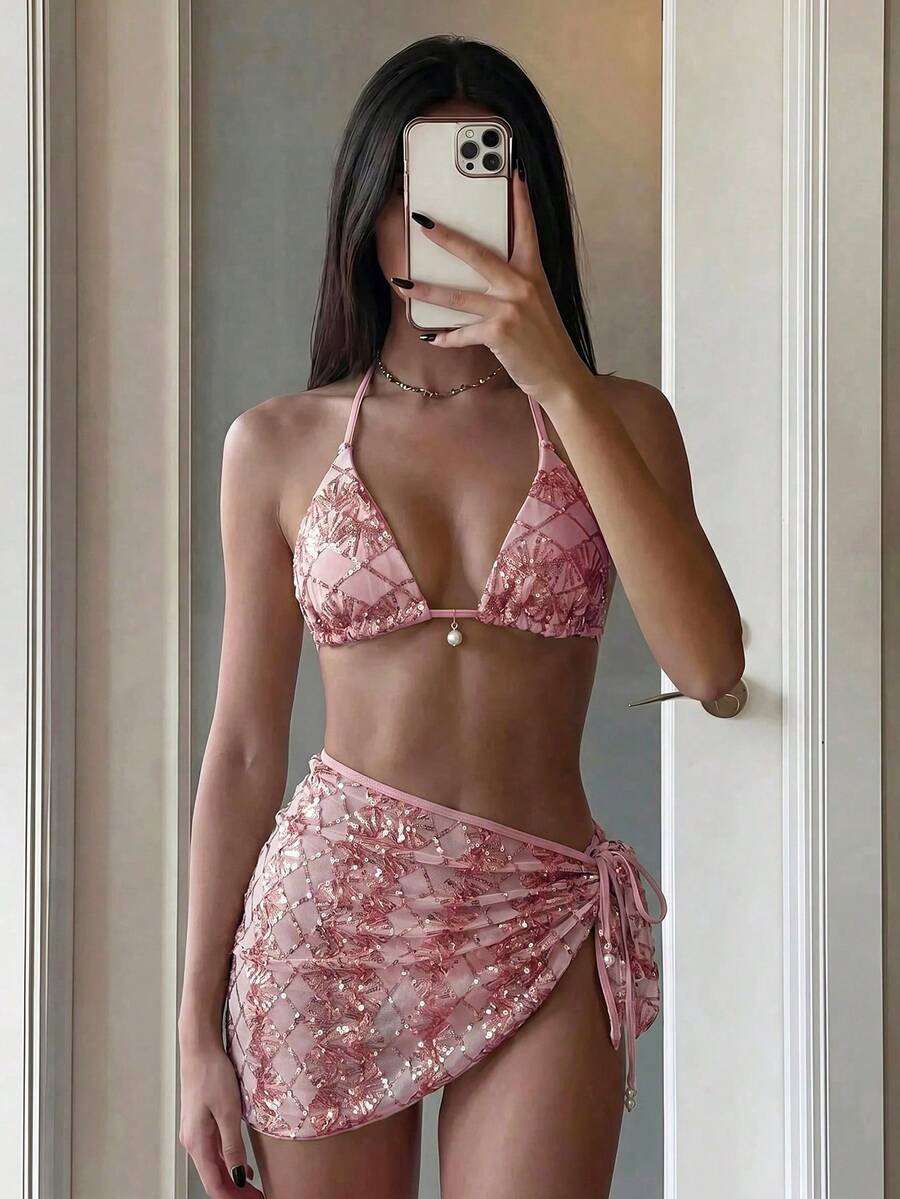 Women's 3-piece blue tropical shell print bikini set featuring a halter bralette top, low-waist tie-side bottom, and a matching sheer mesh cover-up skirt.