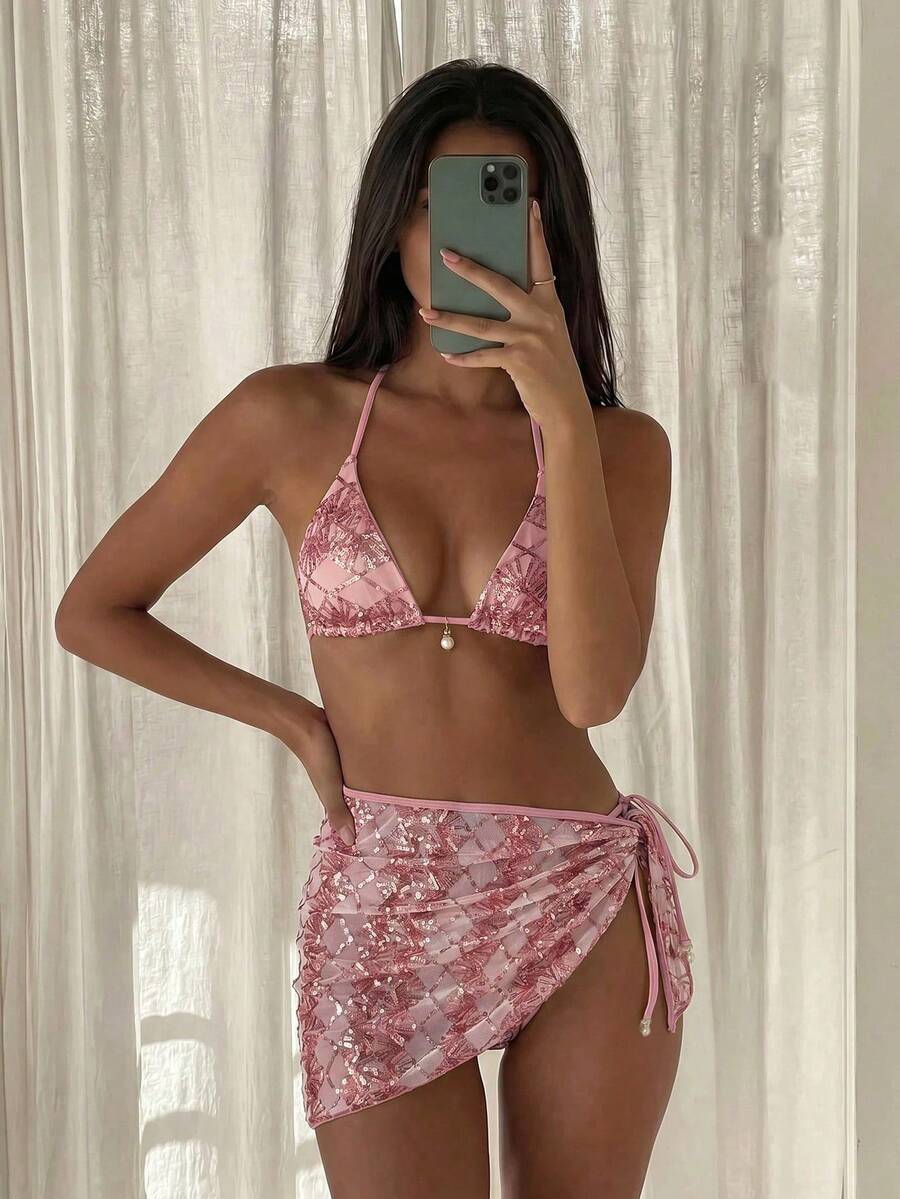 Women's 3-piece blue tropical shell print bikini set featuring a halter bralette top, low-waist tie-side bottom, and a matching sheer mesh cover-up skirt.