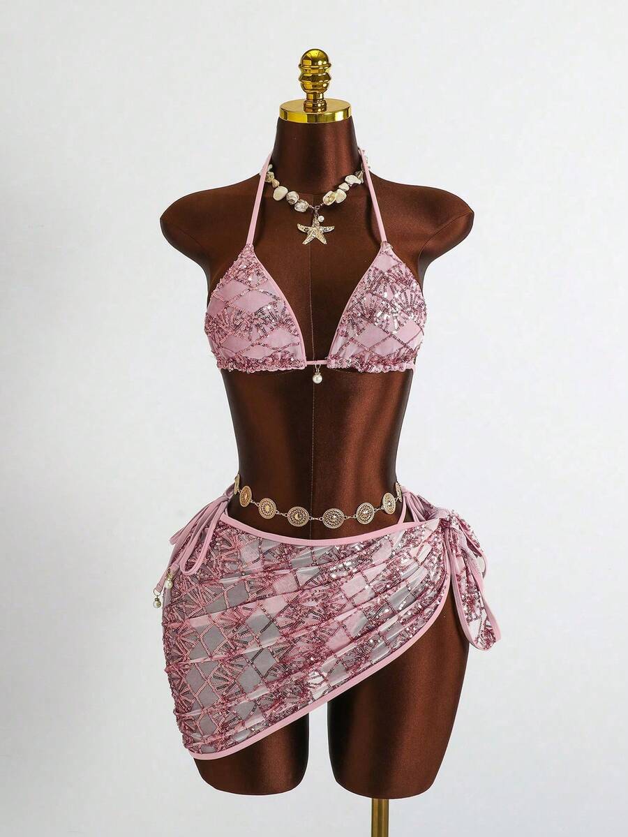 Women's 3-piece blue tropical shell print bikini set featuring a halter bralette top, low-waist tie-side bottom, and a matching sheer mesh cover-up skirt.