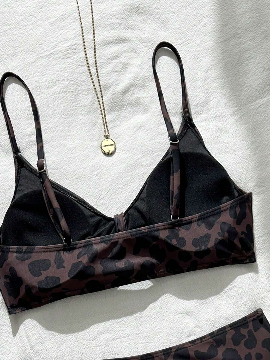 Women's black 2-piece high waist bikini swimsuit set featuring spaghetti straps, criss-cross knot details, wireless bra with removable padding, and high-stretch fabric.